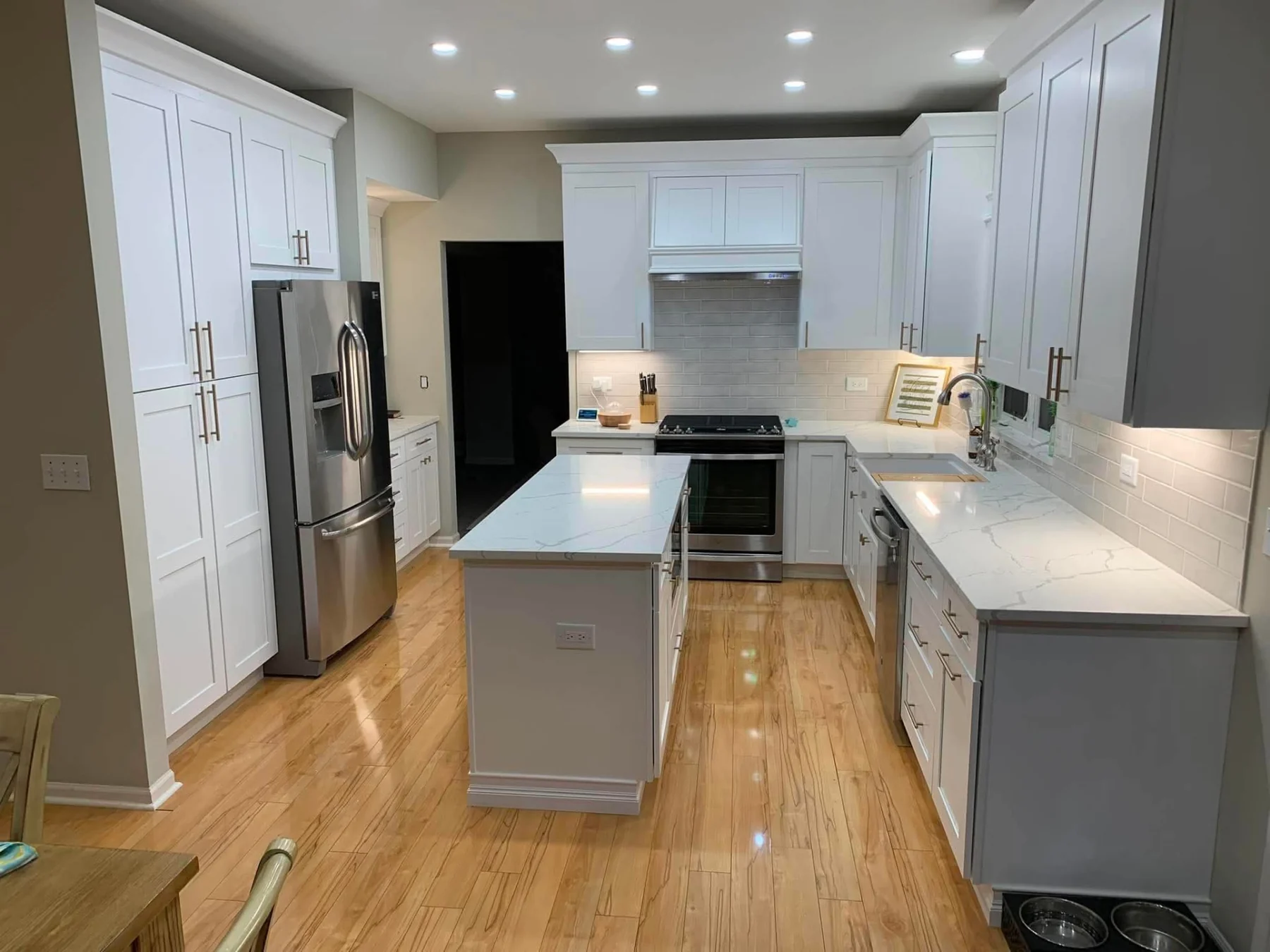 Kitchen with charcoal cabinetry and stone island